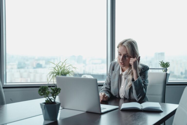 Employee sitting in office in front of laptop