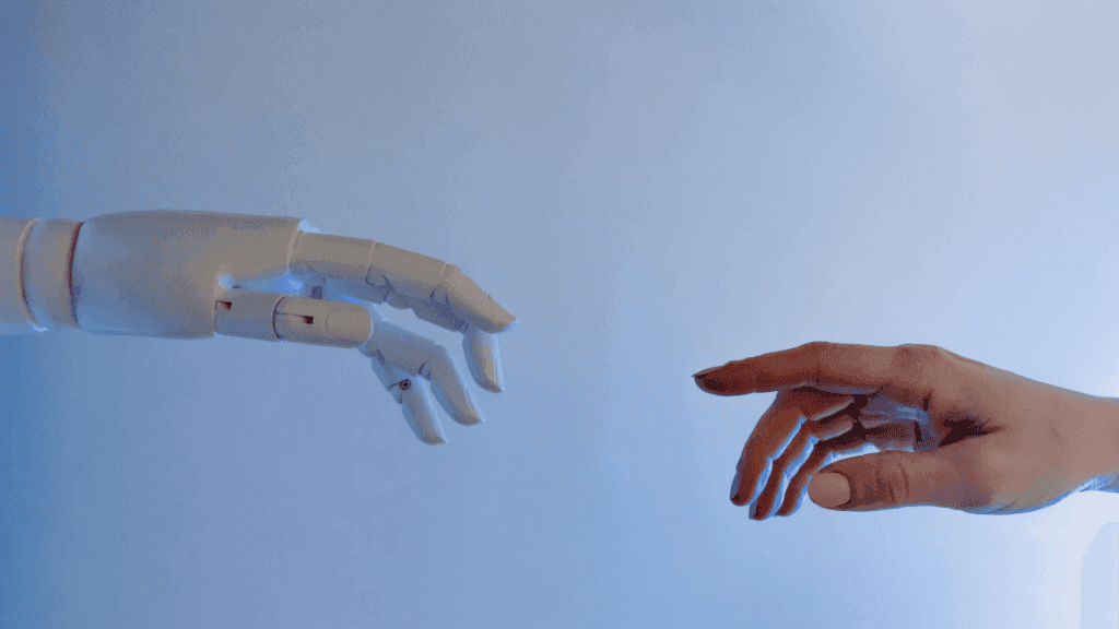 AI and human hand representing the impact of technology in executive recruitment Brisbane