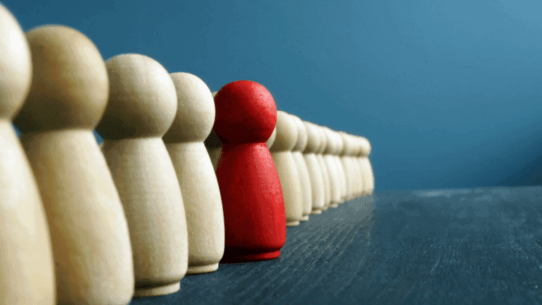 Chess pieces representing standing out in an executive search Brisbane. Chess piece is red.