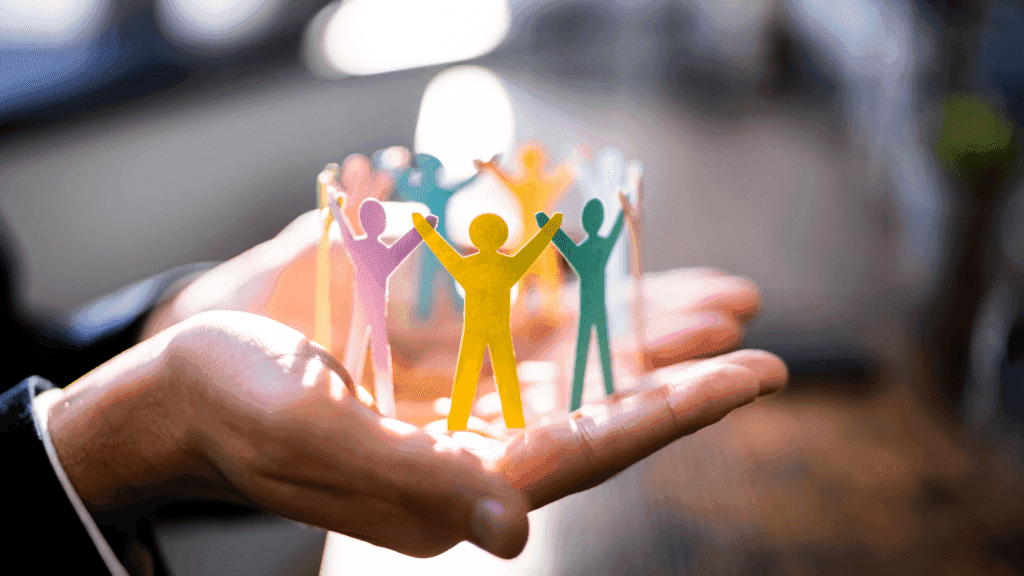 Group of people in the palm of someone's hand to depict leadership development