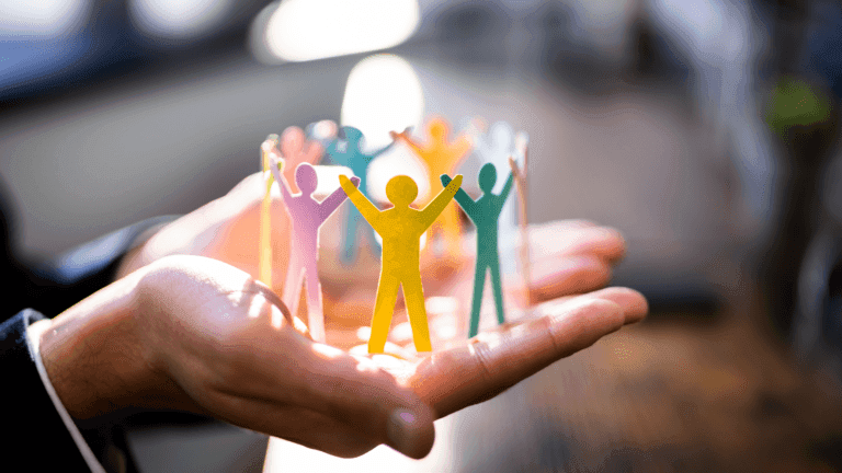 Group of people in the palm of someone's hand to depict leadership development